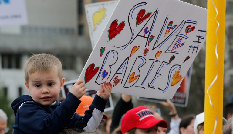 A young boy holds a sign during an anti-abortion rally on the steps of the Capitol in Richmond, Va., Thursday, Feb. 7, 2019.