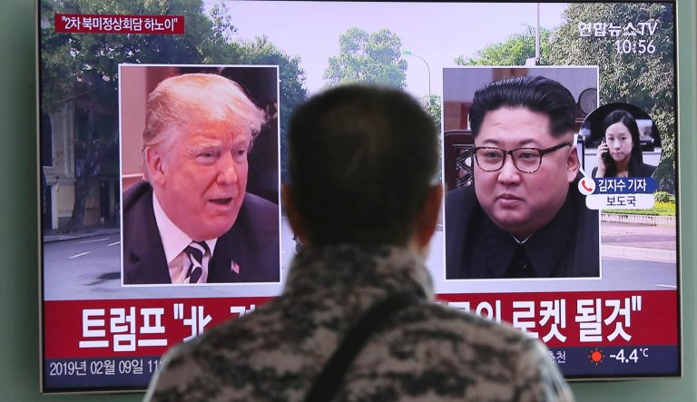 A man watches a TV screen showing images of U.S. President Donald Trump, left, and North Korean leader Kim Jong Un during a news program at the Seoul Railway Station in Seoul, South Korea, Saturday, Feb. 9, 2019.