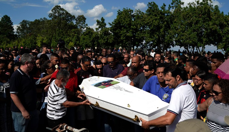 Friends and relatives carry the coffin containing the remains of the young soccer player Arthur Vinicius, one of the victims of a fire at a Brazilian soccer academy, during his burial in Volta Redonda, Brazil.
