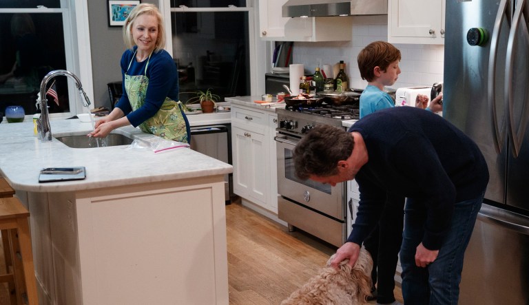Sen. Kirsten Gillibrand, D-N.Y., prepares dinner in her kitchen at home in Washington, Tuesday, Feb. 12, 2019, with her husband Jonathan Gillibrand, their son Henry Gillibrand, and their 2 year-old labradoodle Maple.