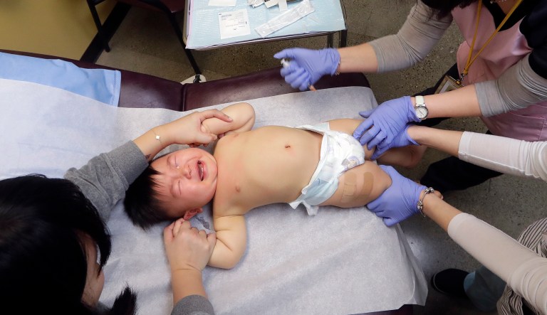 One-year-old Abel Zhang cries as he receives the last of three inoculations, including a vaccine for measles, mumps, and rubella (MMR), at the International Community Health Services Wednesday, Feb. 13, 2019, in Seattle. The boy's tears lasted only a few moments after he received the shots. A recent measles outbreak has sickened dozens of people in the Pacific Northwest, most in Washington state and, of those, most are concentrated in Clark County, just north of Portland, Oregon. Washington Gov. Jay Inslee declared a state of emergency over the outbreak last month. 
