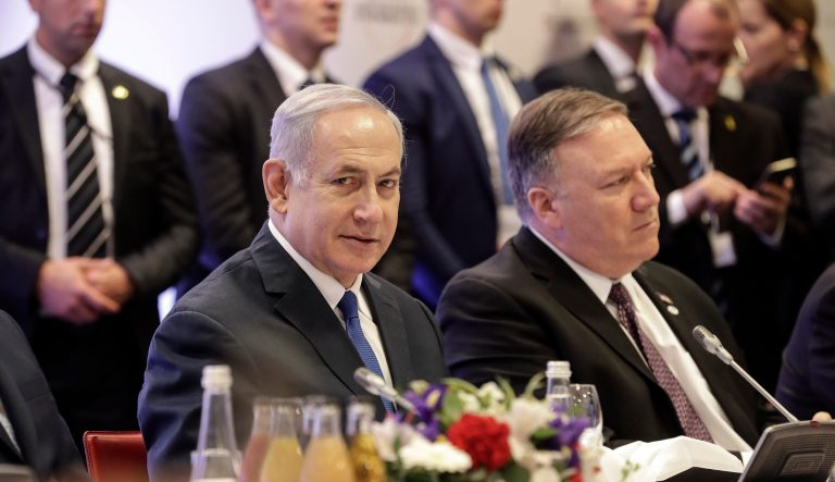 Israeli Prime Minister Benjamin Netanyahu, left, sits beside United State Secretary of State Mike Pompeo, right, at a conference on Peace and Security in the Middle East in Warsaw, Poland, Thursday, Feb. 14, 2019. 