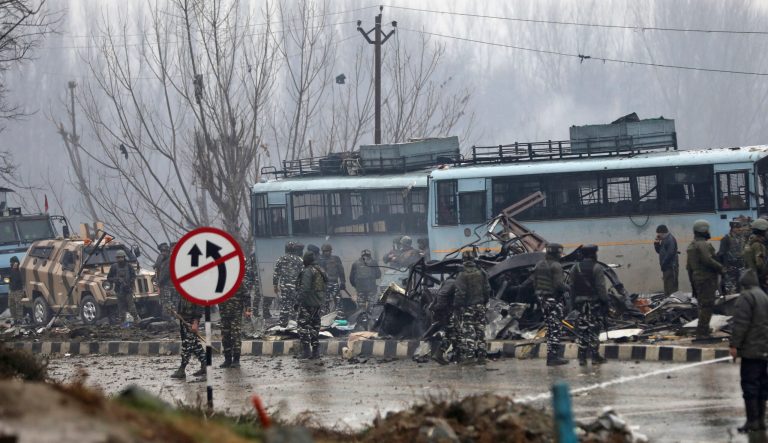 Indian paramilitary soldiers stand by the wreckage of a bus after an explosion in Pampore, Indian-controlled Kashmir, Thursday, Feb. 14, 2019.