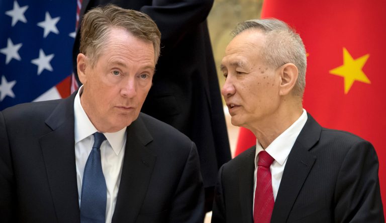 U.S. Trade Representative Robert Lighthizer, left, listens as Chinese Vice Premier Liu He talks while they line up for a group photo at the Diaoyutai State Guesthouse in Beijing, Friday, Feb. 15, 2019. 