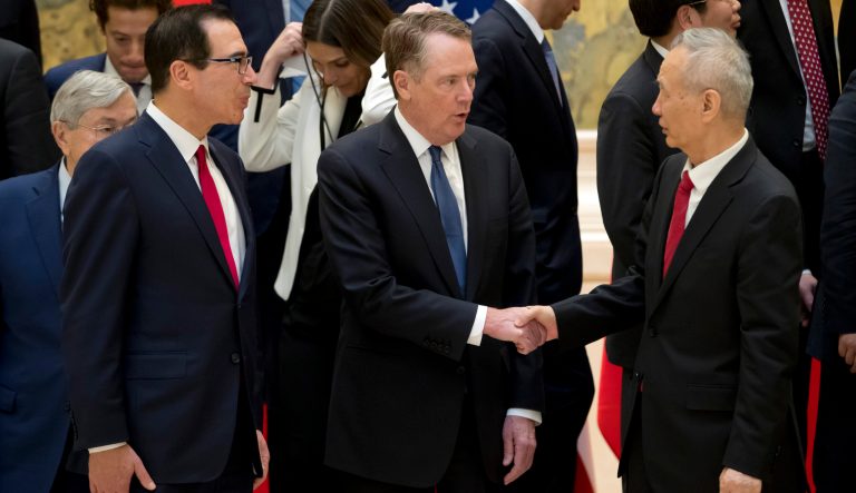 U.S. Trade Representative Robert Lighthizer, center, shakes hands with Chinese Vice Premier Liu He, right, after a group photo at the Diaoyutai State Guesthouse in Beijing, Friday, Feb. 15, 2019. At left is U.S. Treasury Secretary Steven Mnuchin. 