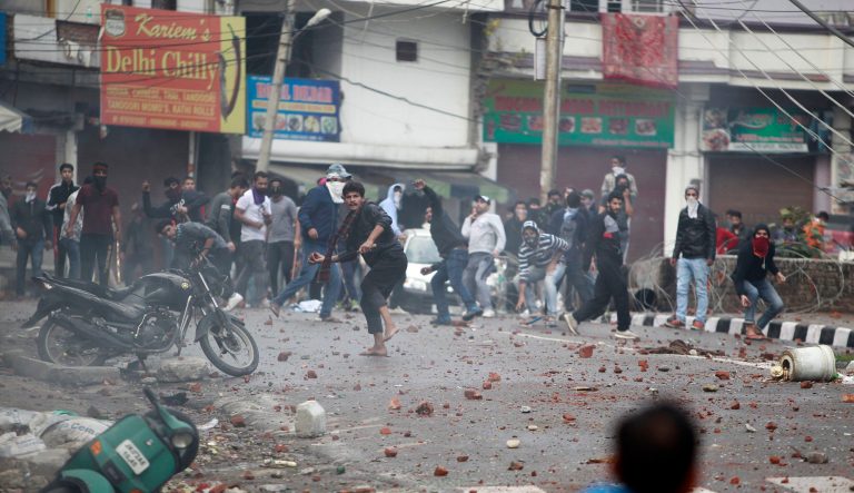 Protestors throw stones during a clash between communities while protesting against Thursday's attack on a paramilitary convoy that killed at least 40 in Kashmir, in Jammu, India, Friday, Feb. 15, 2019.