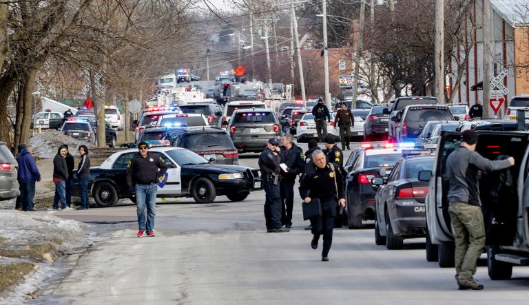 Law enforcement personnel gather near the scene of a shooting at an industrial park in Aurora, Ill., on Friday, Feb. 15, 2019.