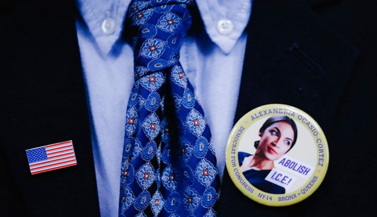 A supporter wears an American flag pin and an Ocasio-Cortez campaign pin to attend the swearing-in ceremony and inaugural address of Rep. Alexandria Ocasio-Cortez, D-N.Y. at the Renaissance School for Musical Theater and Technology in the Bronx borough of New York on Saturday, Feb. 16, 2019. 