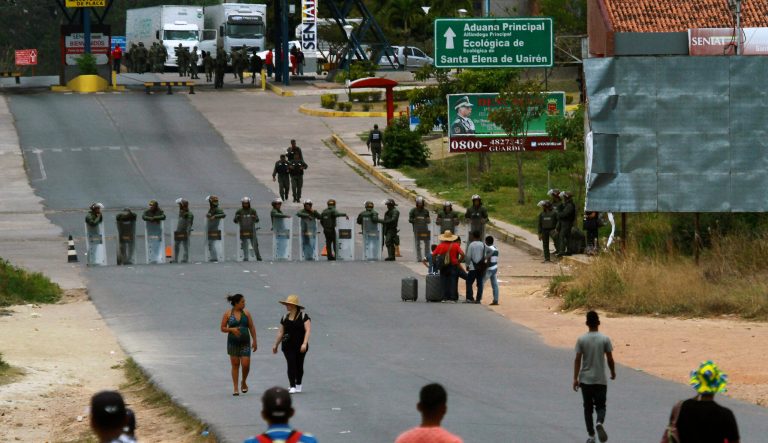 Venezuelan national guards block a road at the border between Brazil-Venezuela, in Pacaraima, Roraima state, Brazil, Friday, Feb. 22, 2019. 