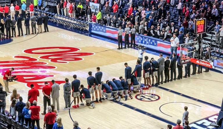 Six Mississippi basketball players take a knee during the national anthem before an NCAA college basketball game against Georgia in Oxford, Miss., Saturday, Feb. 23, 2019. 