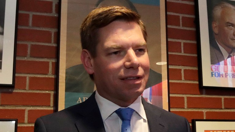 Rep. Eric Swalwell, D-Calif., holds a cup of coffee before speaking at a Politics & Eggs event.