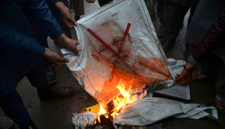 Pakistani protesters burn a poster showing Indian Prime Minister Narendra Modi during an anti-Indian rally in Peshawar, Pakistan, Tuesday, Feb. 26, 2019. Pakistan said India launched an airstrike on its territory early Tuesday that caused no casualties, while India said it targeted a terrorist training camp in a preemptive strike that killed a "very large number" of militants. 