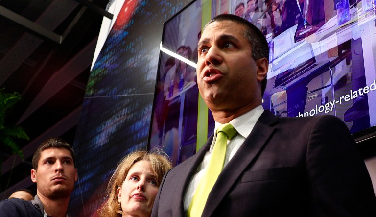 FCC Chairman Ajit Pai (right) talks to the media.