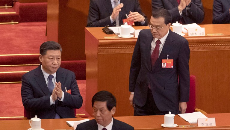 Chinese Premier Li Keqiang, right, prepares to deliver the work report as he walks near Chinese President Xi Jinping at the opening session of the annual National People's Congress.