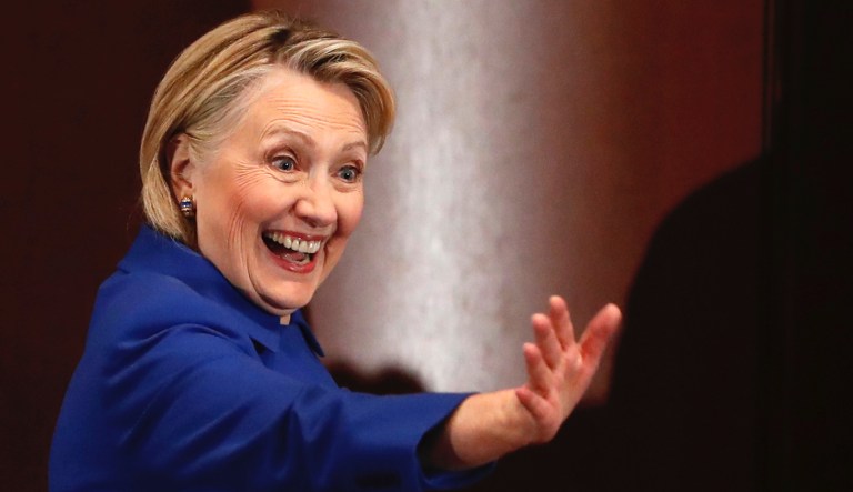 Former Secretary of State Hillary Clinton waves to well-wishers following an appearance at Barnard College with New York Governor Andrew Cuomo.