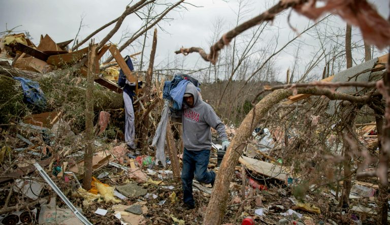 Danny Allen helps recover belongings while sifting through the debris of a friend's home destroyed by a tornado in Beauregard, Ala., Monday, March 4, 2019. 