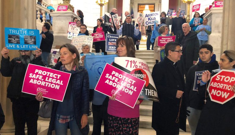 People both supporting and opposing abortion protest at the Statehouse, Tuesday, March 5, 2019, in Providence, R.I., where a house committee is set to vote whether to enshrine abortion protections in state law, joining states around the country that are revisiting their laws in anticipation of renewed federal fights over abortion. 