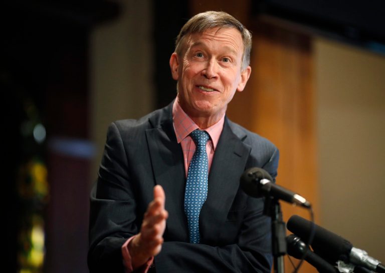 Former Colorado Gov. John Hickenlooper responds to questions during a news conference.