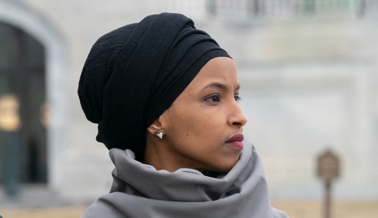Rep. Ilhan Omar, D-Minn., stands with fellow Democrats.