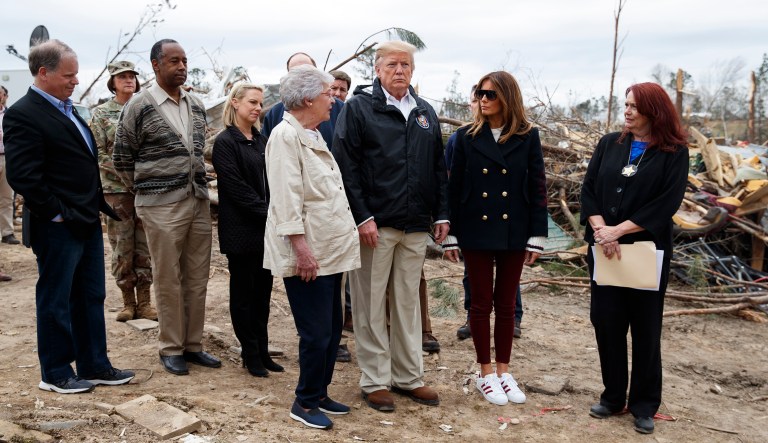 From left, Sen. Doug Jones, D-Ala., Secretary of Housing and Urban Development Ben Carson, Secretary of Homeland Security Kirstjen Nielsen, Alabama Gov. Kay Ivey, President Donald Trump, first lady Melania Trump and Kathy Carson with the Lee County Emergency Management Agency, tour devastation in Beauregard, Ala.