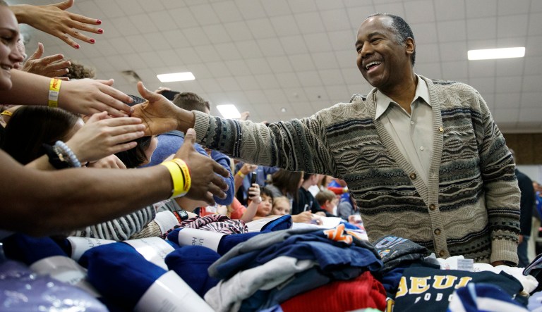 Secretary of Housing and Urban Development Ben Carson greets people at Providence Baptist Church in Smiths Station, Ala., Friday, March 8, 2019, as he,President Donald Trump, and first lady Melania Trump tour areas where tornadoes killed 23 people in Lee County, Ala.