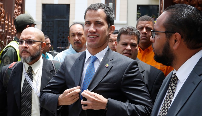 National Assembly President Juan Guaido, who declared himself interim president of Venezuela, adjusts his blazer as he arrives to lead a session of the opposition-controlled assembly in Caracas, Venezuela, Monday, March 11, 2019.