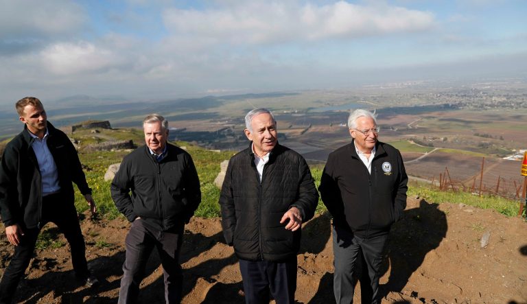 Israeli Prime Minister Benjamin Netanyahu, center, Republican U.S. Senator Lindsey Graham, second left, and U.S. Ambassador to Israel David Friedman, right, visit the border between Israel and Syria at the Israeli-held Golan Heights, Monday, March 11, 2019. 