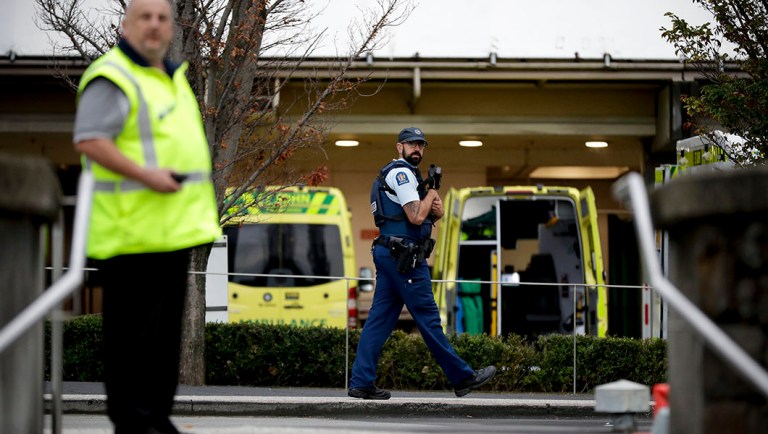 Law enforcement members stand guard at Christchurch Hospital.