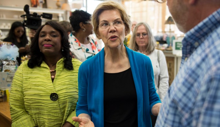 Democratic presidential candidate Sen. Elizabeth Warren, D-Mass., center, talks with owner Tim Williamson at Cater's Drug Store in Selma, Ala., on Tuesday, March 19, 2019.