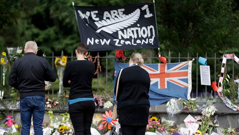 Visitors to the Botanical Gardens look at a floral tribute for the mosque shootings in Christchurch, New Zealand.