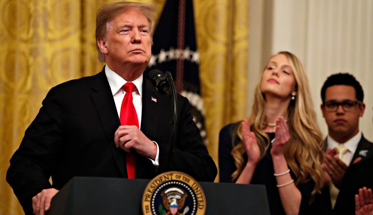 President Donald Trump adjusts his blazer as he speaks before signing an executive order requiring colleges to certify that their policies support free speech as a condition of receiving federal research grants, Thursday March 21, 2019, in the East Room of the White House in Washington. 