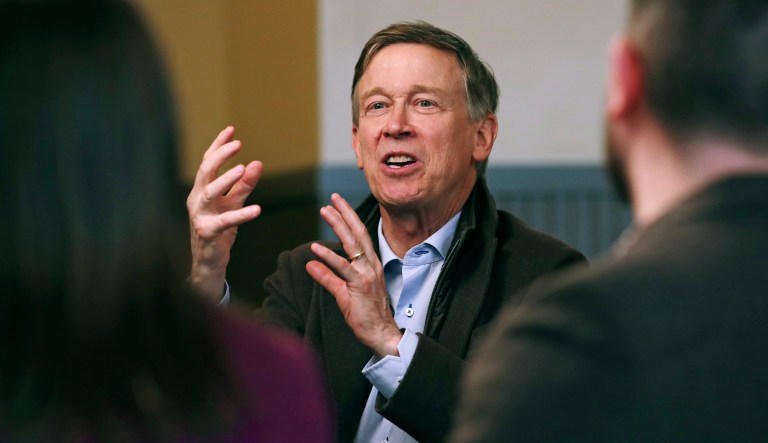 Former Democratic Colorado Gov. John Hickenlooper gestures during a meeting with AmeriCorps members at a roundtable campaign stop in Manchester, N.H., Friday, March 22, 2019.