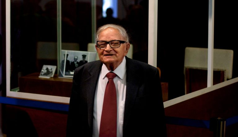 In this Monday, Dec. 12, 2011 file photo, Israeli Rafi Eitan, right, stands next to a showcase during an opening of an exhibition about Eichmann's capture at the Knesset, Israel's parliament in Jerusalem. Eitan, a legendary Israeli Mossad spy who led the capture of Holocaust mastermind Adolf Eichmann, has died. He was 92. 