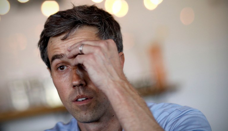 Democratic presidential candidate and former Texas congressman Beto O'Rourke wipes sweat from his brow as he speaks at a campaign stop.
