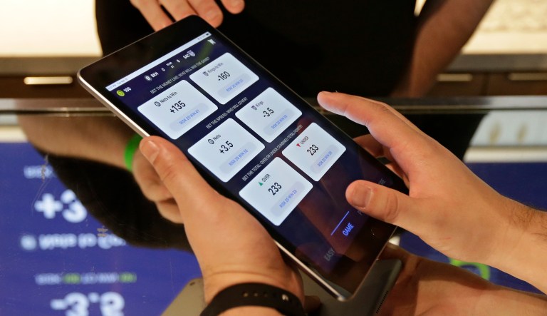 In this March 19, 2019, photo, Zack Shelton, of Swish Analytics explains how to place a bet at the Skyloft Predictive Gaming Lounge inside the Golden 1 Center, home of the NBA's Sacramento Kings, in Sacramento, Calif.