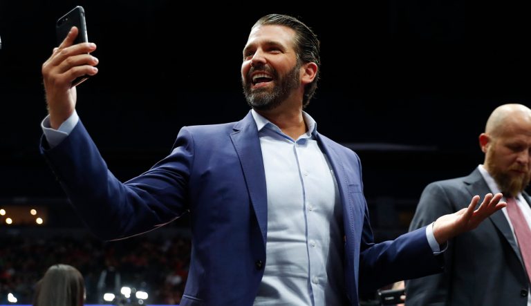 Donald Trump Jr. takes video of the crowd during a rally in Grand Rapids, Mich., Thursday, March 28, 2019. 