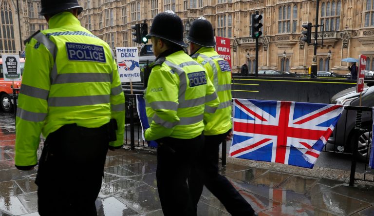 Three policemen patrol past various Brexit flags and banners outside the Houses of Parliament in London, Tuesday, April 2, 2019. Britain's Prime Minister Theresa May is set for long Cabinet meeting Tuesday, as the government tries to find a way out of the Brexit crisis, after lawmakers on Monday rejected all alternatives to her European Union withdrawal agreement.