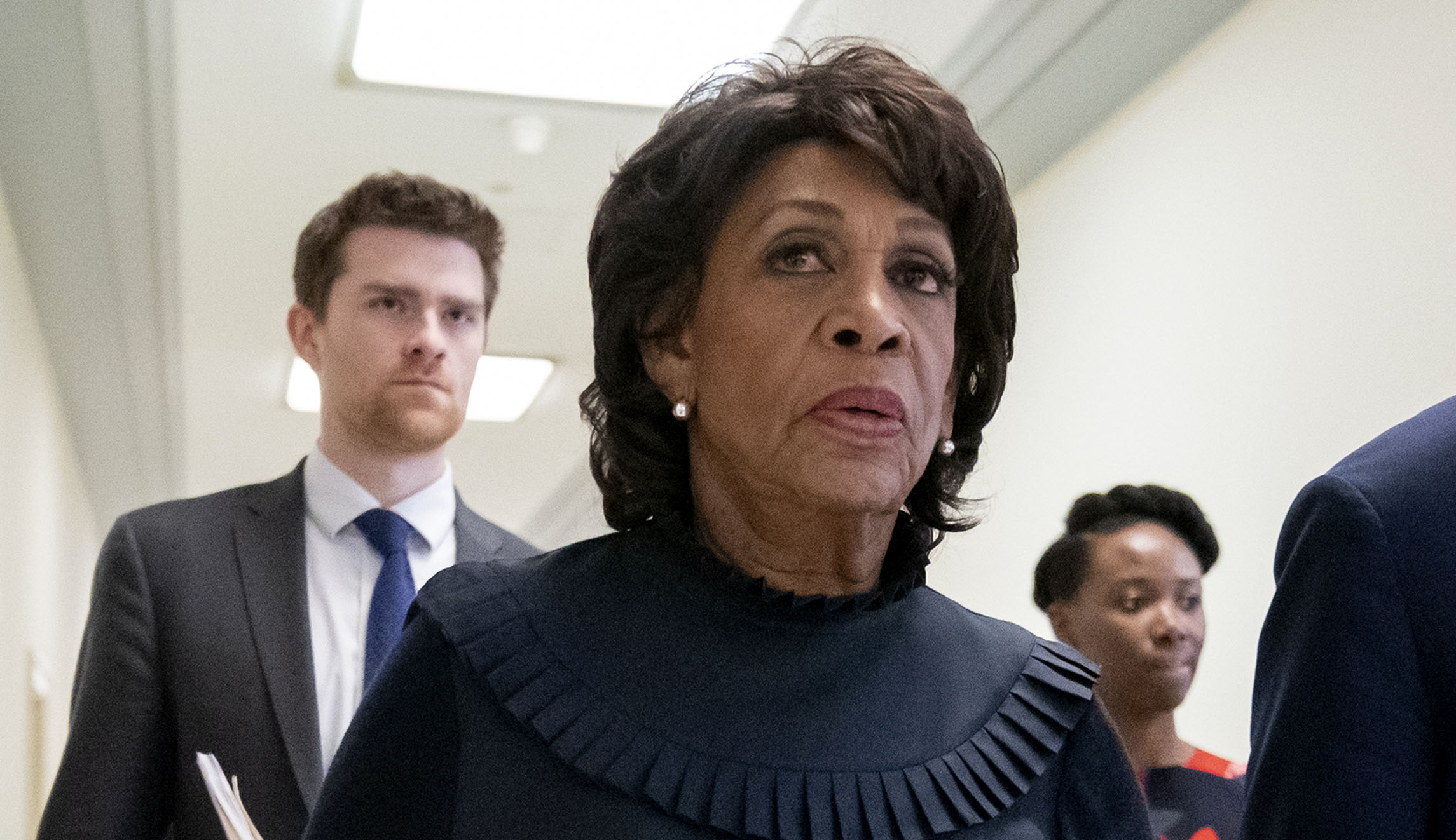 House Financial Services Committee Chairwoman Maxine Waters, D-Calif., walks with staff members on Capitol Hill in D.C.