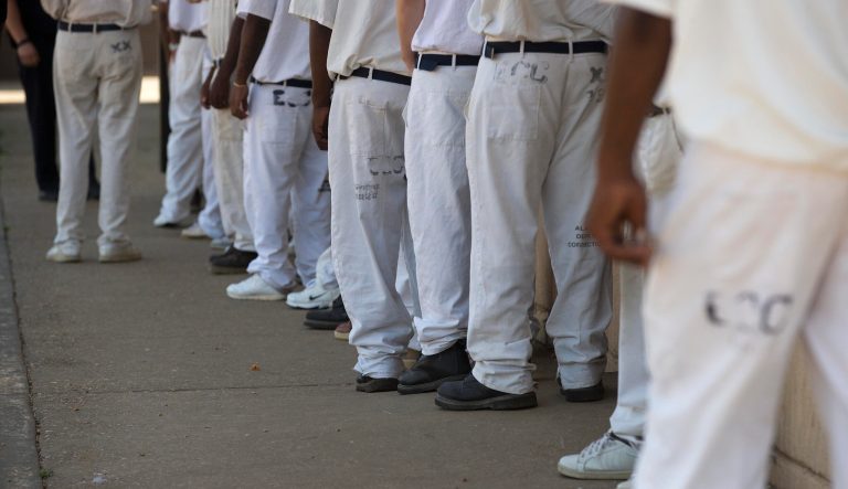 In this June 18, 2015 photo, prisoners stand in a crowded lunch line during a prison tour at Elmore Correctional Facility in Elmore, Ala. The Justice Department has determined that Alabama's prisons are violating the Constitution by failing to protect inmates from violence and sexual abuse and by housing them in unsafe and overcrowded facilities, according to a scathing report Wednesday, April 3, 2019, that described the problems as "severe" and "systemic." 