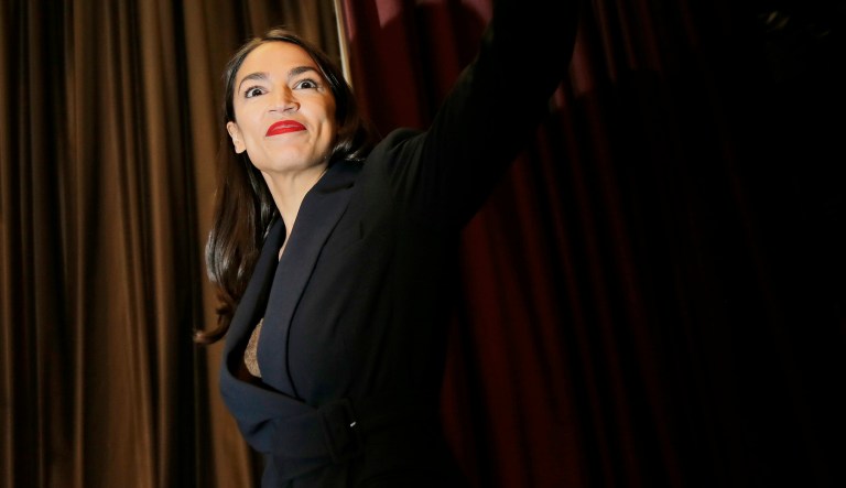 Rep. Alexandria Ocasio-Cortez, D-N.Y., arrives on the stage before speaking during the National Action Network Convention in New York, Friday, April 5, 2019.