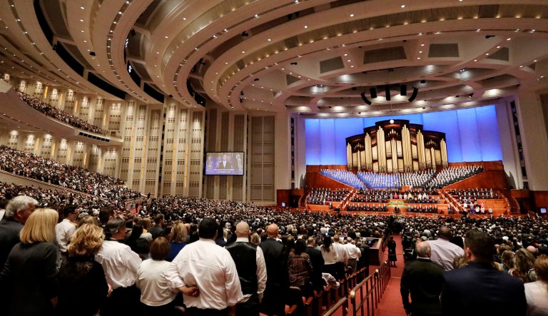 People listen to the Tabernacle Choir at Temple Square as they perform during The Church of Jesus Christ of Latter-day Saints conference on April 6 in Salt Lake City. Church members are preparing for more changes as they gather in Utah for a twice-yearly conference to hear from the faith's top leaders.
