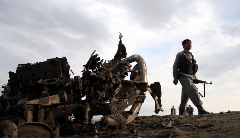 Afghan security forces gather at the site of Monday's attack near the Bagram Air Base, north of Kabul, Afghanistan, Tuesday, April 9, 2019. Three American service members and a U.S. contractor were killed when their convoy hit a roadside bomb on Monday near the main U.S. base in Afghanistan, the U.S. forces said. The Taliban claimed responsibility for the attack.