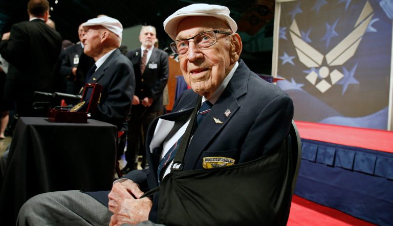 In this April 18, 2015 photo, retired U.S. Air Force Lt. Col. Richard "Dick" Cole, seated front, poses for photos after the presentation of a Congressional Gold Medal honoring the Doolittle Tokyo Raiders at the National Museum of the U.S. Air Force at Wright-Patterson Air Force Base in Dayton, Ohio. Retired Lt. Col. Richard "Dick" Cole, the last of the 80 Doolittle Tokyo Raiders who carried out the daring U.S. attack on Japan during World War II, has died at a military hospital in Texas. He was 103.