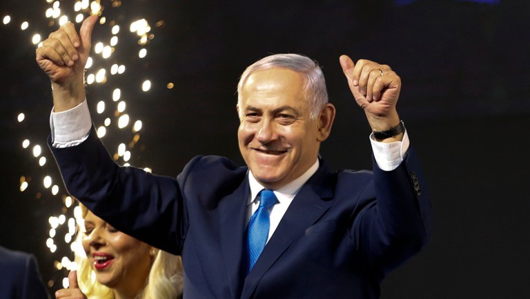 Israel's Prime Minister Benjamin Netanyahu waves to his supporters.