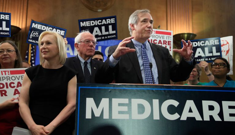 Sen. Jeff Merkley, D-Ore., right, joined by Sen. Bernie Sanders, I-Vt., and Sen . Kirsten Gillibrand, D-N.Y. speaks during a gathering introducing the Medicare for All Act of 2019, on Capitol Hill in Washington, Wednesday, April 10, 2019. 