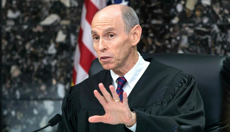 Judge Leonard Hanser talks with attorneys during a hearing in New England Patriots owner Robert Kraft's prostitution solicitation case in West Palm Beach, Fla.