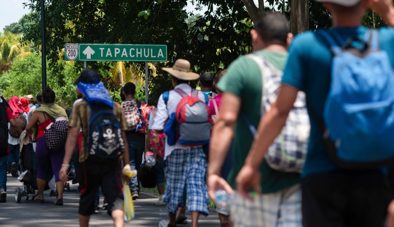 Central American migrants, part of a caravan hoping to reach the U.S. border, walk on the shoulder of a road in Frontera Hidalgo, Mexico, Friday, April 12, 2019. The group pushed past police guarding the bridge and joined a larger group of about 2,000 migrants who are walking toward Tapachula, the latest caravan to enter Mexico.