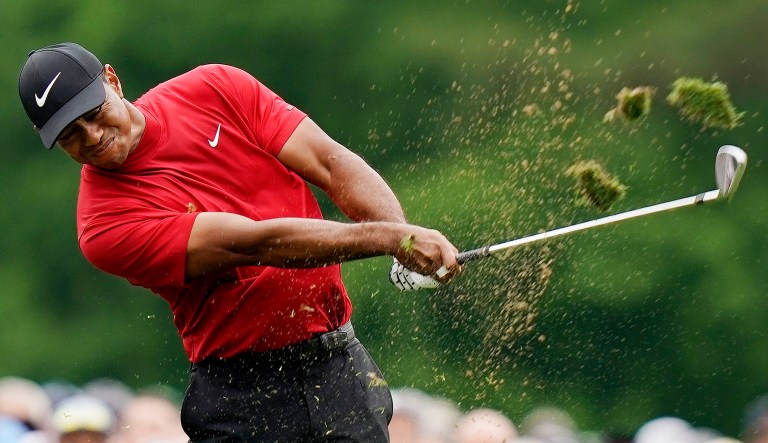 Tiger Woods hits on the 12th hole during the final round for the Masters golf tournament, Sunday, April 14, 2019, in Augusta, Ga. 