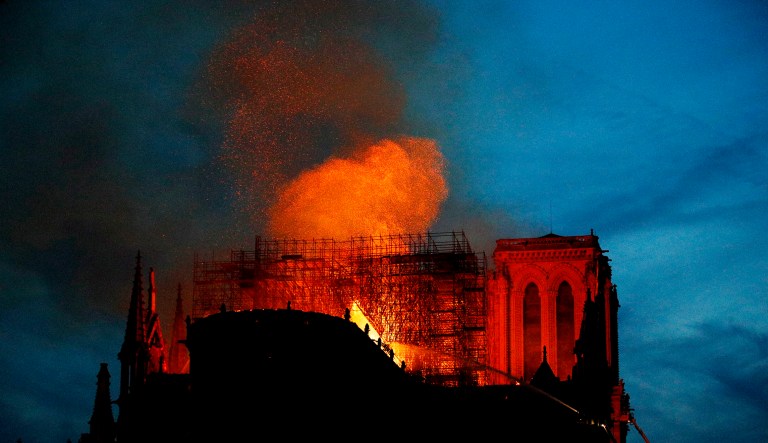 Firefighters use hoses as Notre Dame cathedral burns in Paris, Monday.