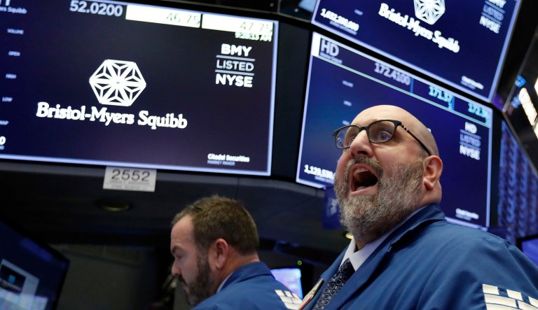 Specialist Peter Giacchi, right, calls out prices for Bristol-Myers Squib on the floor of the New York Stock Exchange.